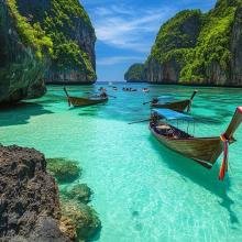 Clear turquoise water with wooden boats surrounded by lush green cliffs under a vibrant blue sky, conveying a serene tropical paradise.